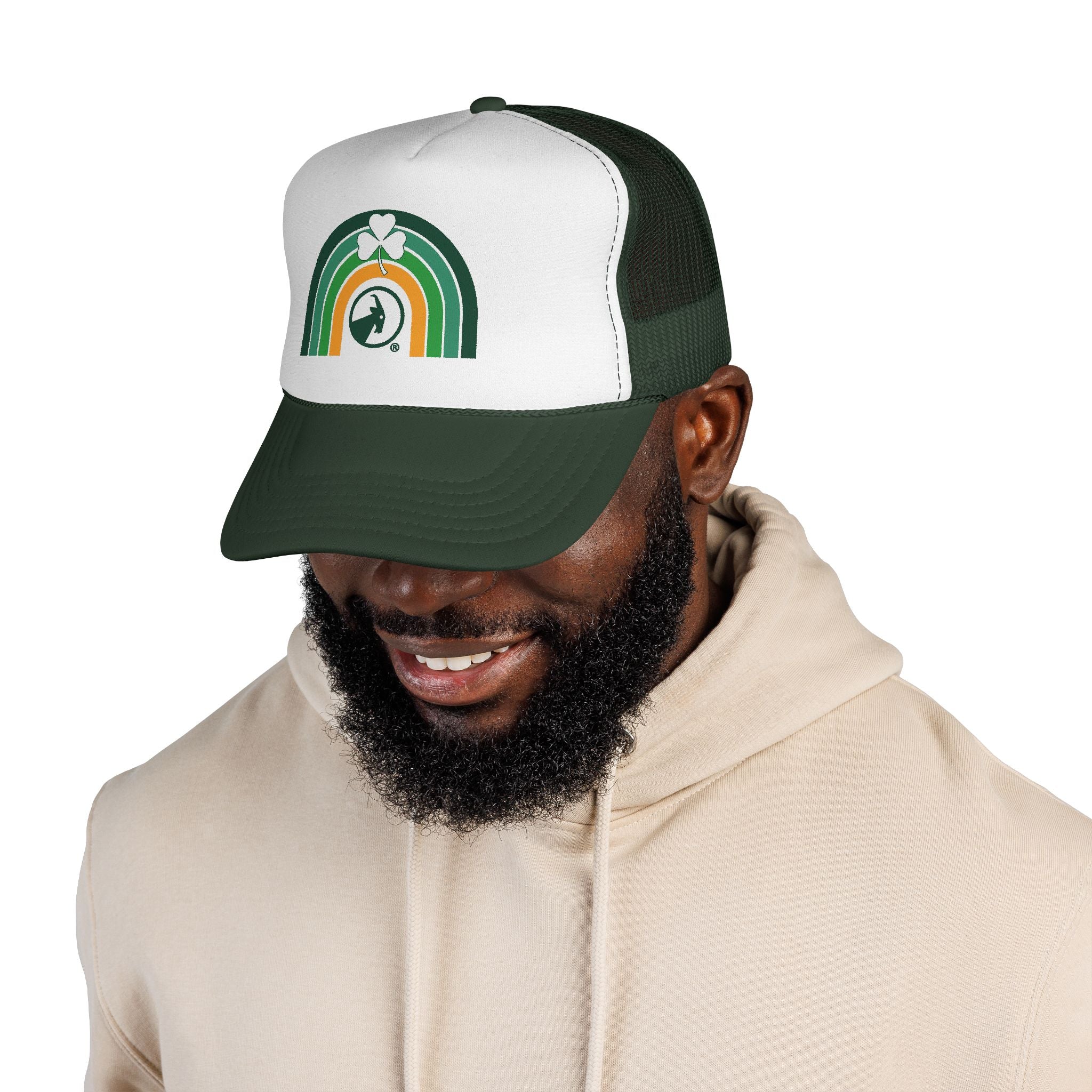 Man wearing a green and white cap with text, smiling on a white background