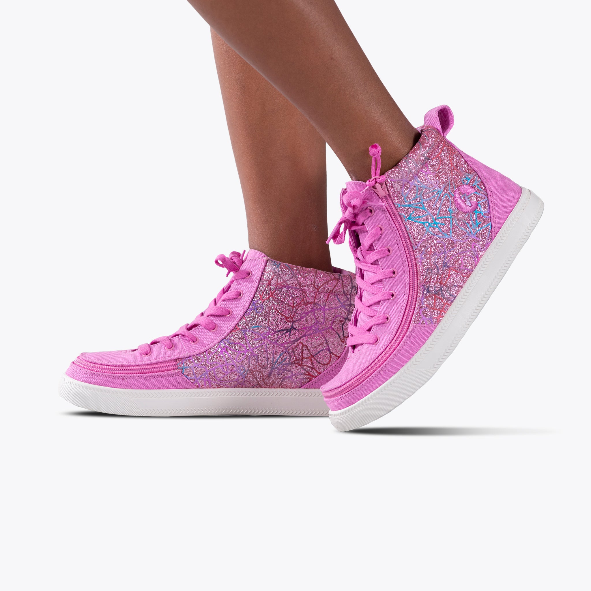 Someone stands against a plain white background wearing SALE - Pink Print BILLY Classic Lace High sneakers from BILLY Footwear, featuring a vibrant pink print and a signature wraparound zipper.