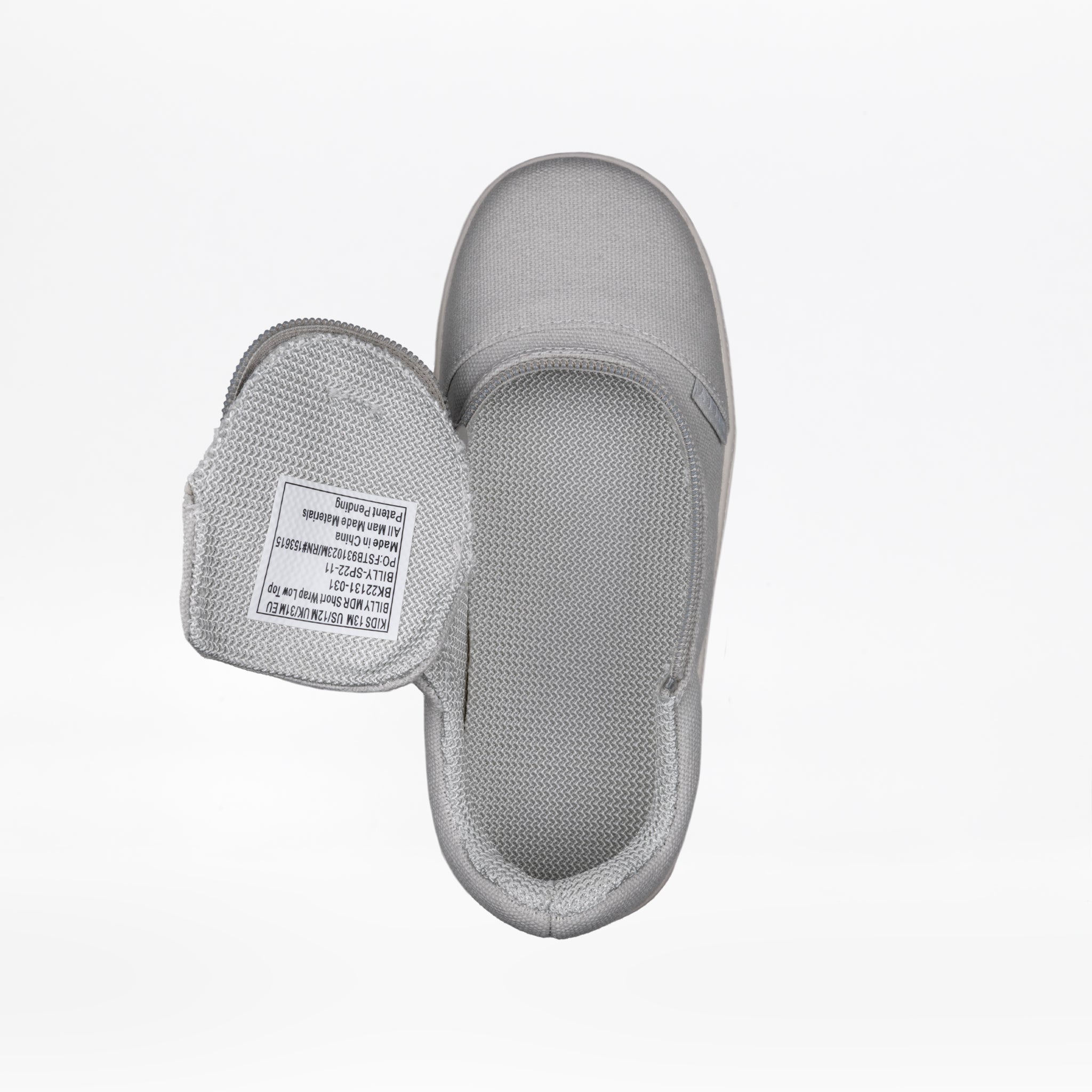 A top view of the FINAL SALE - Grey BILLY D|R Short Wrap Low Tops by BILLY Footwear, a light gray kids' adaptive slip-on shoe with an open hook-and-loop strap showing the white label inside, displayed on a plain white background.