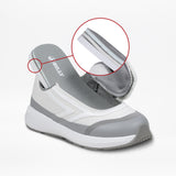 The SALE - White BILLY Goat by BILLY Footwear is a gray and white sneaker with a fold-down heel and easy on-and-off zipper, highlighted for its AFO-friendly, accessible design in a zoomed-in circle.