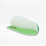 A pair of green foam insoles, one stacked on top of the other. The top insole displays a small red chili pepper and "BALL" near the heel—ideal for kids’ BILLY Footwear Wicked Black Glitz BILLY CS High sneakers.