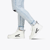 Wearing light blue ripped skinny jeans and White/Black BILLY CS High sneakers from BILLY Footwear with a full wrap zipper, this person stands against a plain white background.