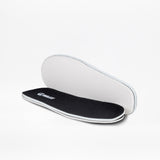 A pair of Black to the Floor BILLY Sport Inclusion insoles by BILLY Footwear are shown, with one displaying the black cushioned top and the other revealing the white underside, designed for athletic zipper shoes or kids sneakers.