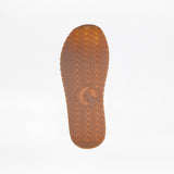 Close-up of a brown rubber sole from the Lilac BILLY Retro Jogger by BILLY Footwear, featuring a herringbone tread and central circular logo, shown against a plain white background.