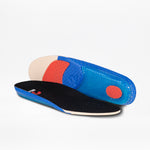 A pair of colorful insoles for the Men's Black Suede BILLY Comfort Chukka by BILLY Footwear, one lying flat and one propped up to show the blue, red, and beige textured underside with a black top and blue trim, on a white background.