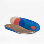 A pair of orthopedic insoles featuring a blue textured base, red cushioning, beige heel support, and brown upper—ideal for the Men's Sand Suede BILLY Comfort Chukka by BILLY Footwear—displayed on a white background.