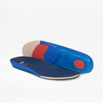 Two blue insoles—one flat, one propped to reveal red and beige textured soles—are shown on a white background. Ideal for Men's Navy/White BILLY CS High sneakers from BILLY Footwear.