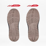 Two taupe Men's BILLY Inclusion Trail Boot soles from BILLY Footwear are displayed side by side on a white background, with the left labeled Medium and the right labeled Wide to show the difference in width.
