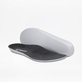 Two charcoal/yellow BILLY Footwear insoles for men's Inclusion Trail shoes are shown on a white background—one lies flat to display the branded top, while the other is propped to reveal its contoured underside.
