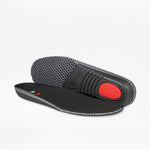 A pair of BILLY Footwear Men's Black/Charcoal/Black BILLY Comfort DZ High insoles—one flat, one propped—reveals textured grip, a red cushioned heel, and stylish gray and black accents, ideal for comfortable walking shoes.