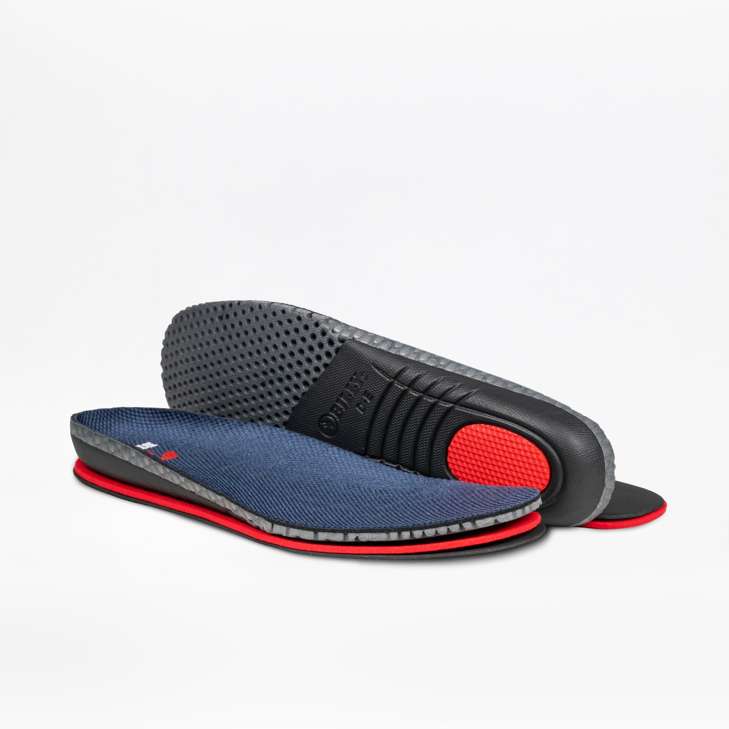A pair of Men's Navy Suede BILLY Comfort Plush insoles by BILLY Footwear, featuring navy fabric tops, red sides, and black textured bottoms, are shown on a white background—one flat, one propped to display the sole.