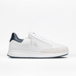 The Men's White/Navy BILLY Comfort Court by BILLY Footwear is a minimalist, low-cut white sneaker with a blue heel tab, white laces, and a white sole, shown in side profile on a white background.