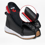 Black shoe with white sole and red interior, featuring a close-up of the sole on a light gray background.