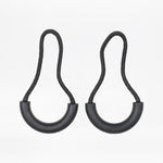Two black zipper pulls with rubber half loops and black cord on a white background