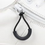 Black loop zipper pull attached to a white sneaker