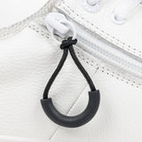 Black loop zipper pull attached to a white sneaker