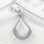 Light Grey loop zipper pull attached to a white sneaker