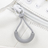 Light Grey loop zipper pull attached to a white sneaker