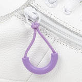 Purple loop zipper pull attached to a white sneaker