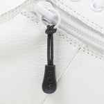 Black sport zipper pull with BILLY word mark attached to a white sneaker