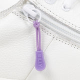 Purple sport zipper pull with BILLY word mark attached to a white shoe