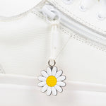 White daisy charm on a white background