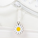 White daisy charm on a white background