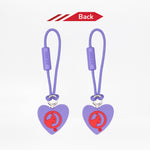 Reverse side of two heart-shaped zipper pulls with a red goat logo on a white background.