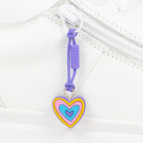 Heart-shaped zipper pull with colorful design on a white shoe 