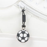 Black soccer ball zipper pull on a white shoe