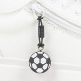 Black soccer ball zipper pull on a white shoe