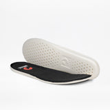 Pair of insoles, one showing the black branded top and one showing the white perforated underside.