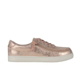 Rose gold sneaker with a zipper on a white background