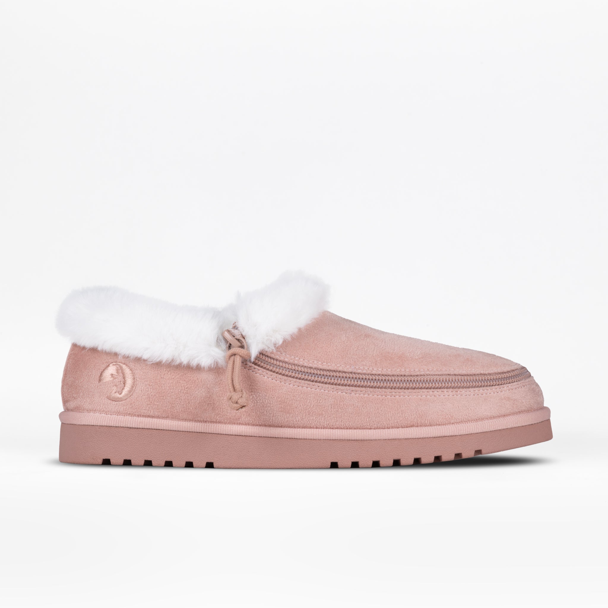 The BILLY Footwear Women's Cozy Slipper in blush suede features a thick sole, white faux fur lining, full wrap zipper, and textured outsole for grip—offering warmth and comfort, shown against a plain white background.
