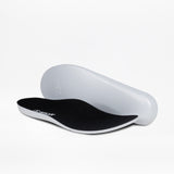The Women's Black/White BILLY Sport Inclusion insoles by BILLY Footwear are shown on a white background: one lies flat, the other is propped up, both feature a black top and white base, designed for comfortable women's sneakers.