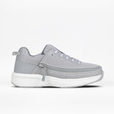 The Women's Grey BILLY Limitless by BILLY Footwear features a light gray mesh upper, thick white sole, laces, and a side zipper for easy on-off. The sneaker is shown against a plain white background.
