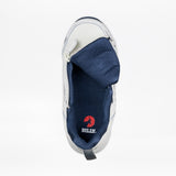 The Women's White/Navy BILLY Limitless 253 by BILLY Footwear is shown from above with an open side zipper, revealing the red BILLY logo insole, a folded tongue, sensory friendly design, and dark blue mesh lining.