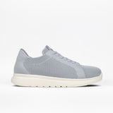 A grey Women's Comfort Knit sneaker by BILLY Footwear with a white sole, shown in profile on a white background. This low-top, breathable shoe features a perforated design and a medial zipper.