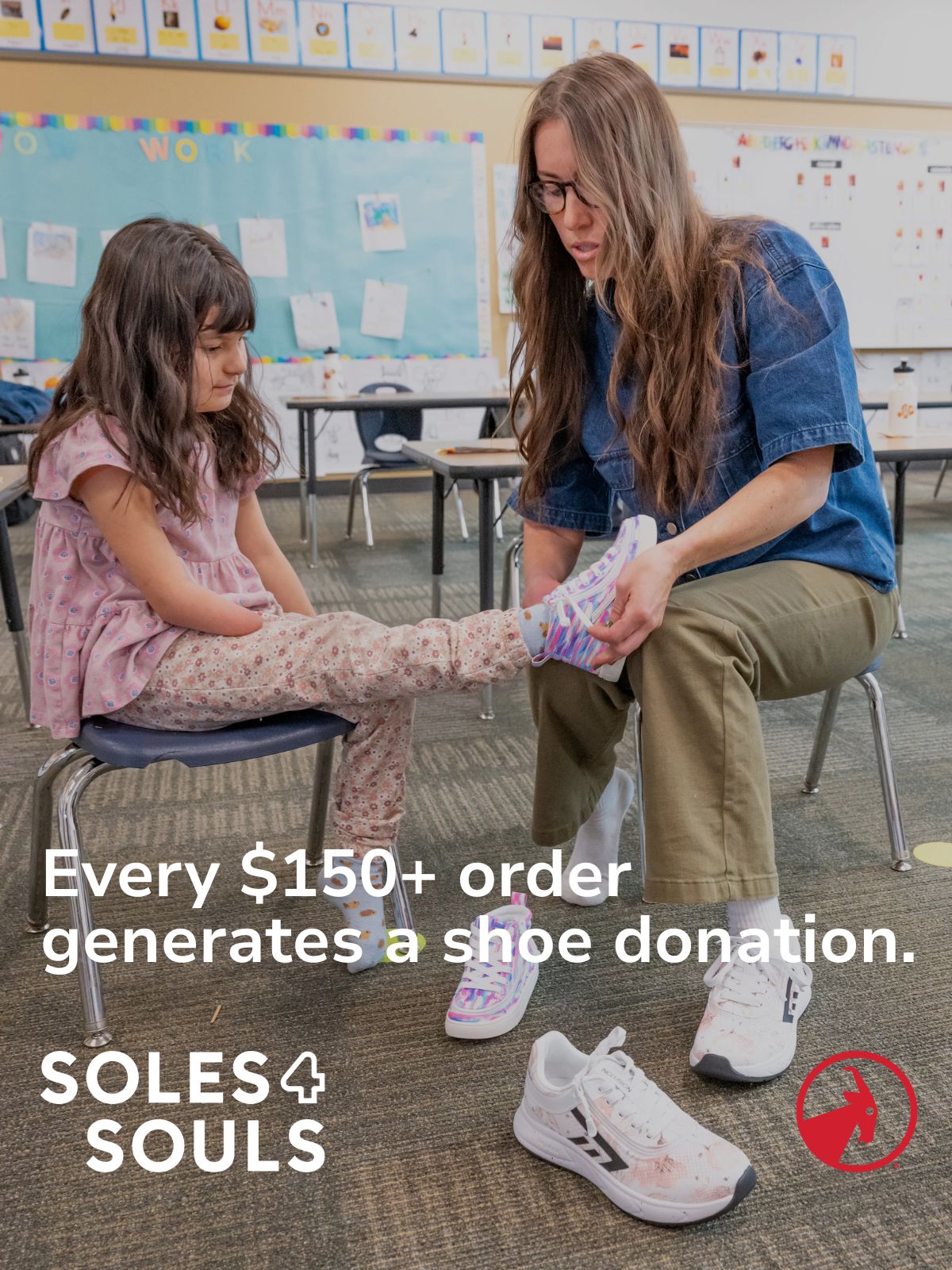 Woman helping a child put on a shoe in a classroom with SOLES4SOULS branding.